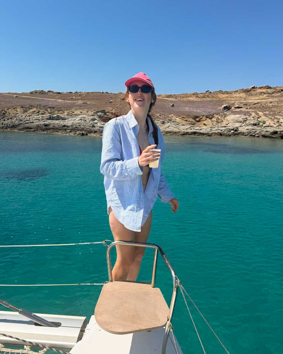 Hannah holding drink on the catamaran cruise in Naxos Greece