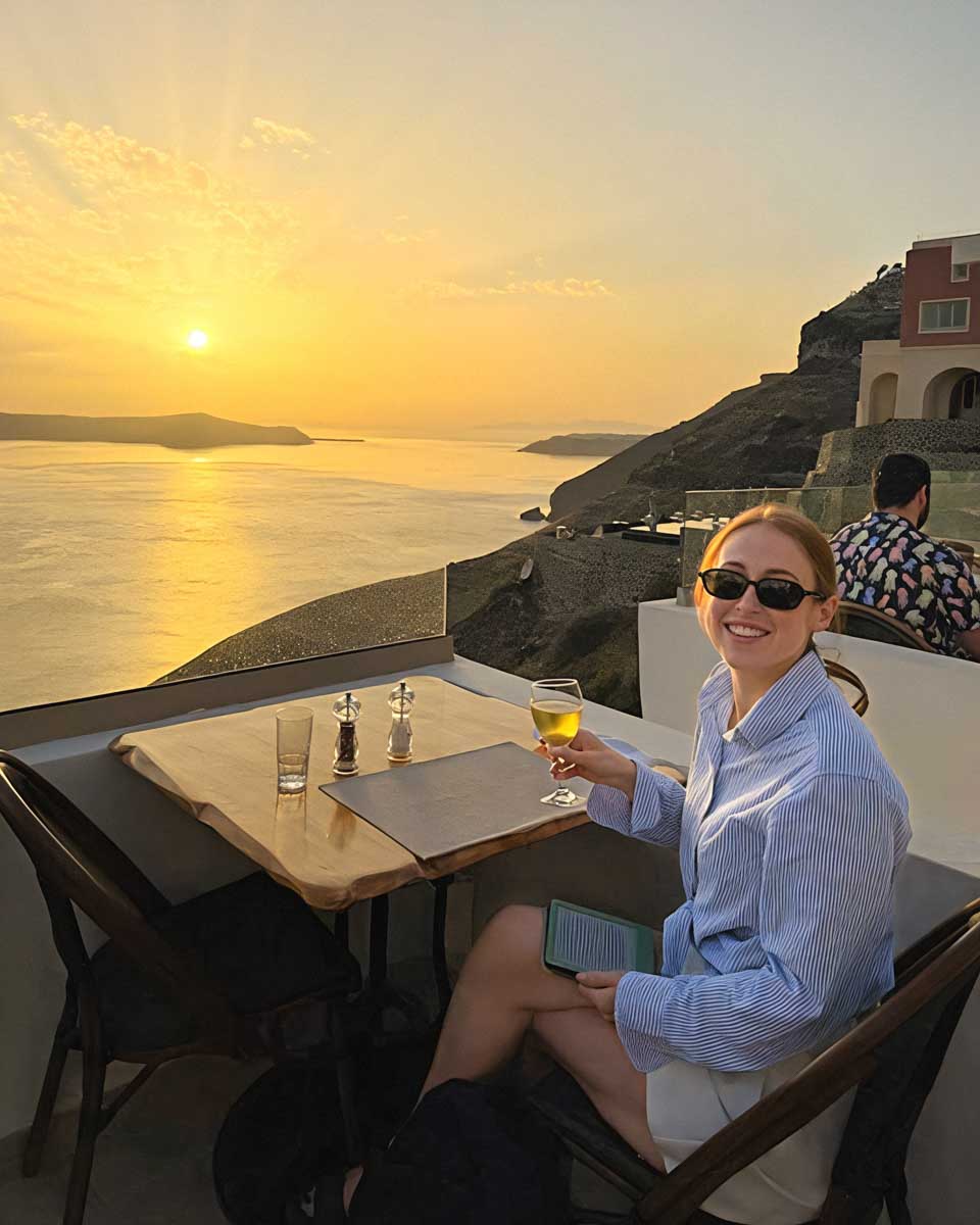 Hannah in restaurant in Fira Santorini on Hannah trip