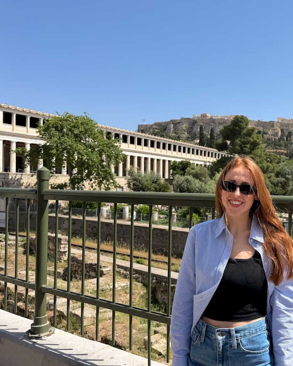 Hannah with Ancient Agora behind her in Athens Greece
