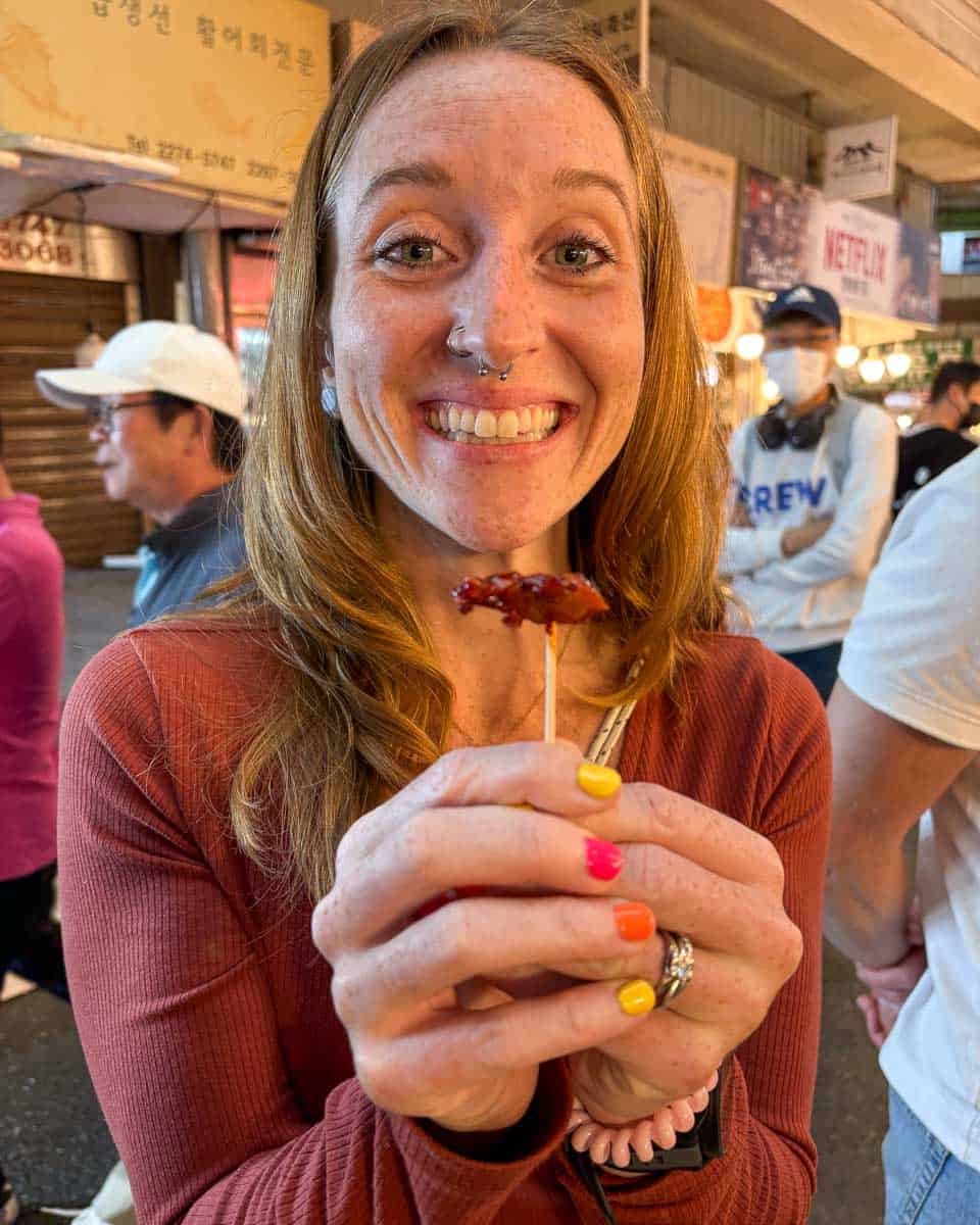Meghan eats spicy rice cake on a food tour in Gwangjang Market, Seoul South Korea 1