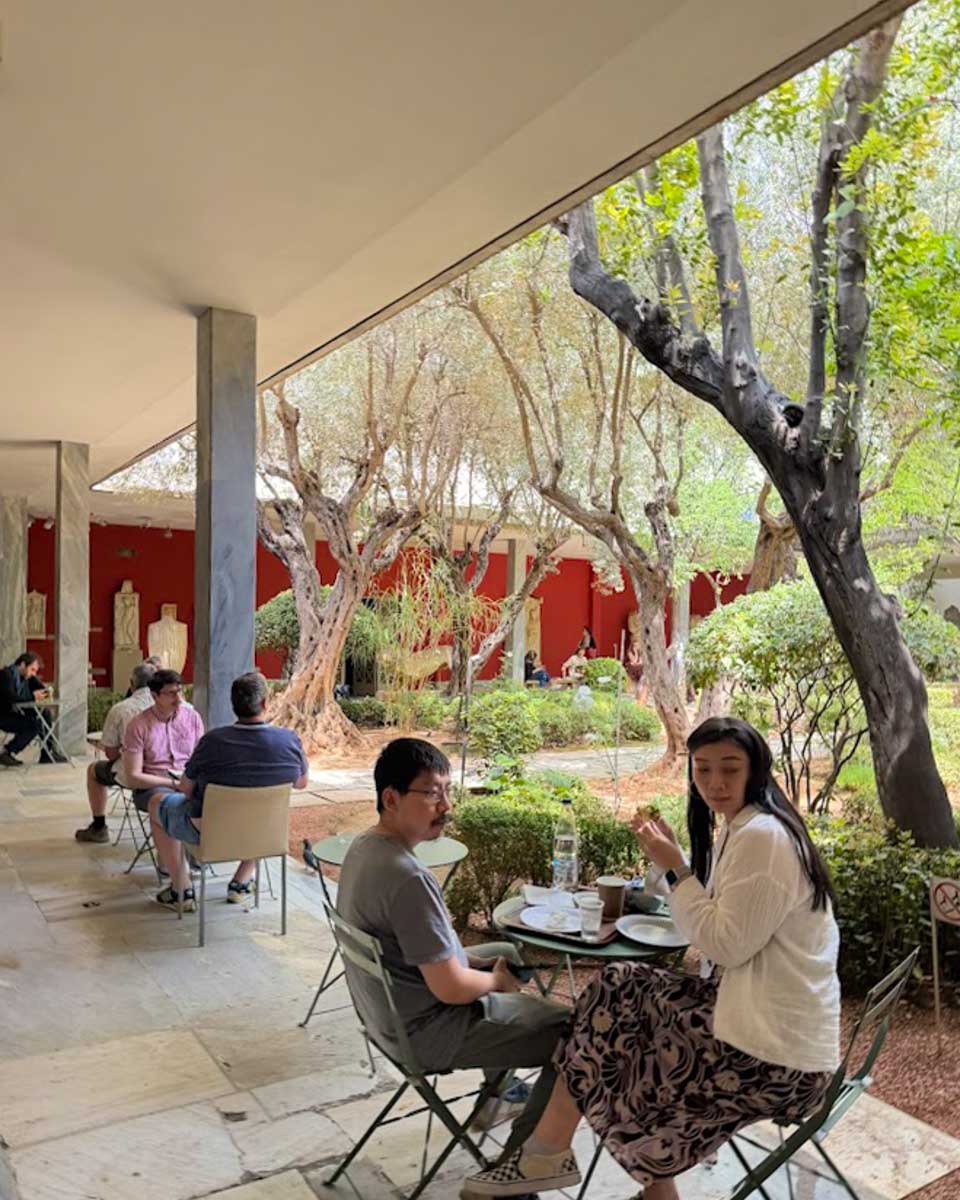 People sitting at the National Archaeological Museum in Athens Greece on Hannah trip