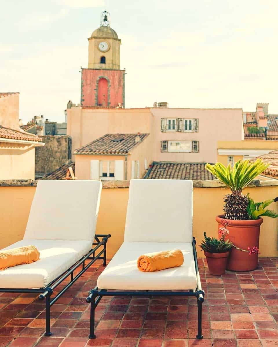 Sun loungers on a balcony with a city view at Hotel la Ponche in St Tropez