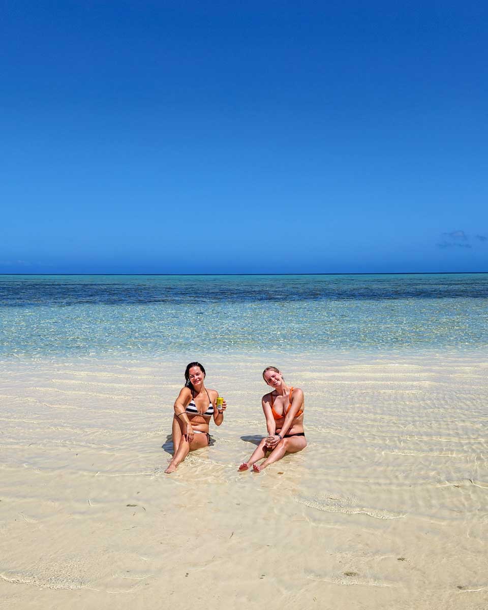 Two-people-relax-in-the-shallow-waters-of-Bora Bora
