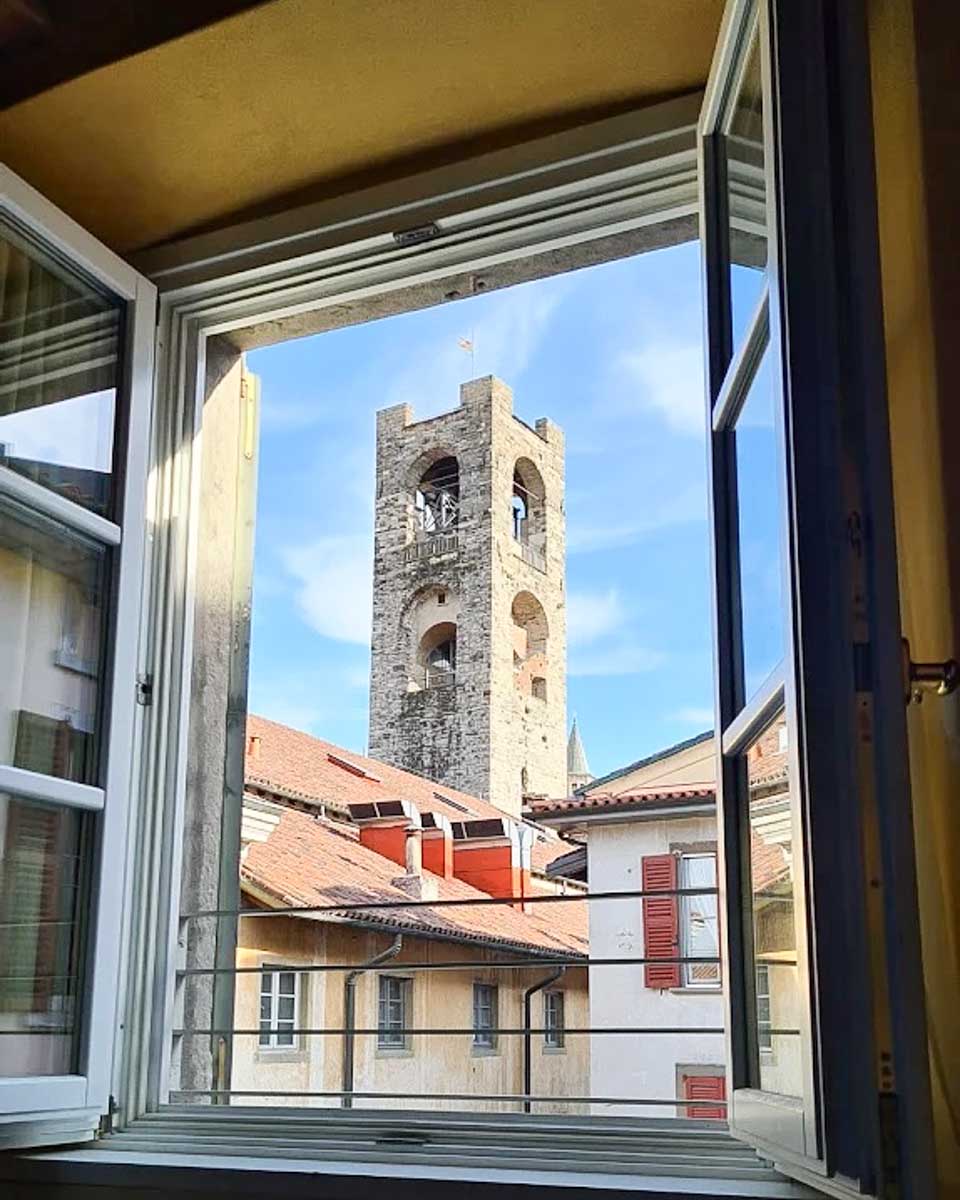 View of the bell tower out the window at Hotel Piazza Vecchia in Bergamo