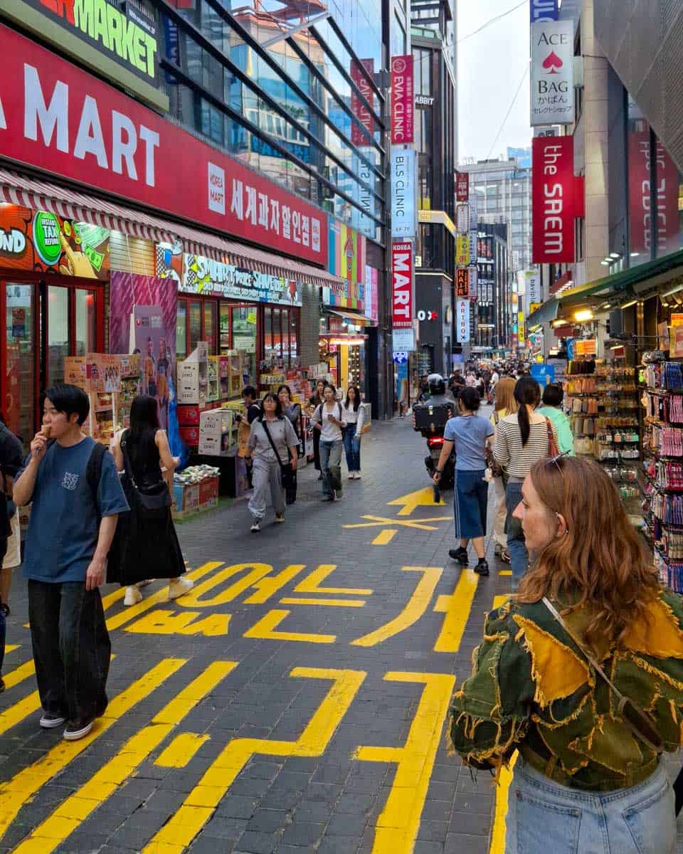 Walking down Myeong-dong Shopping Street in Seoul South Korea
