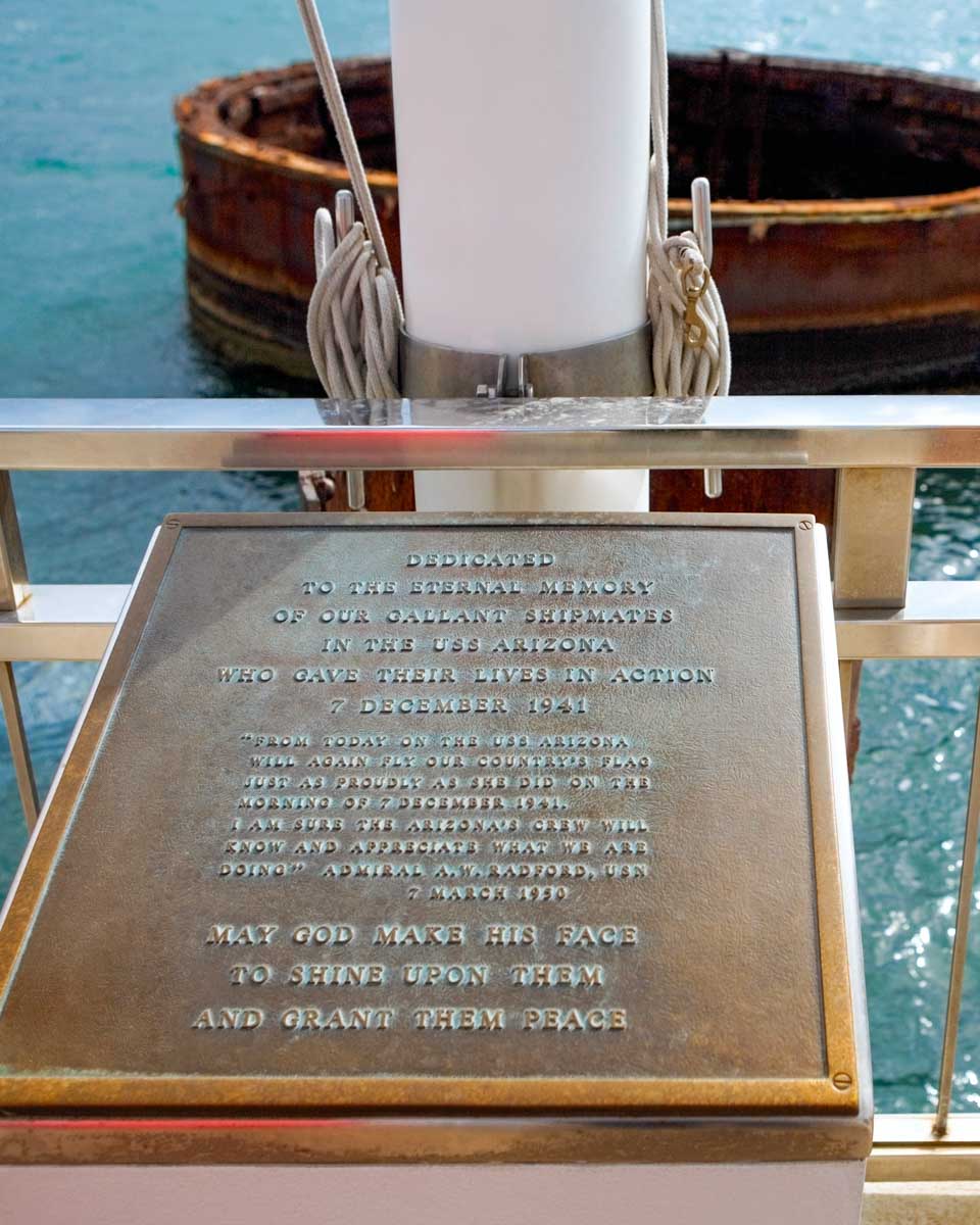 A plaque and view of USS Arizona wreckage on a Pearl Harbor tour in Hawaii