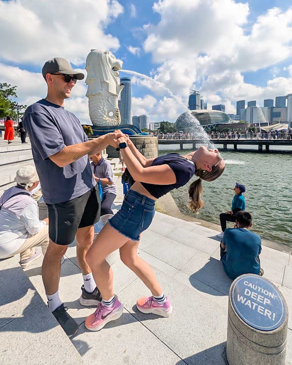 Bailey and Daniel posing by the Merlion at Marina Bay