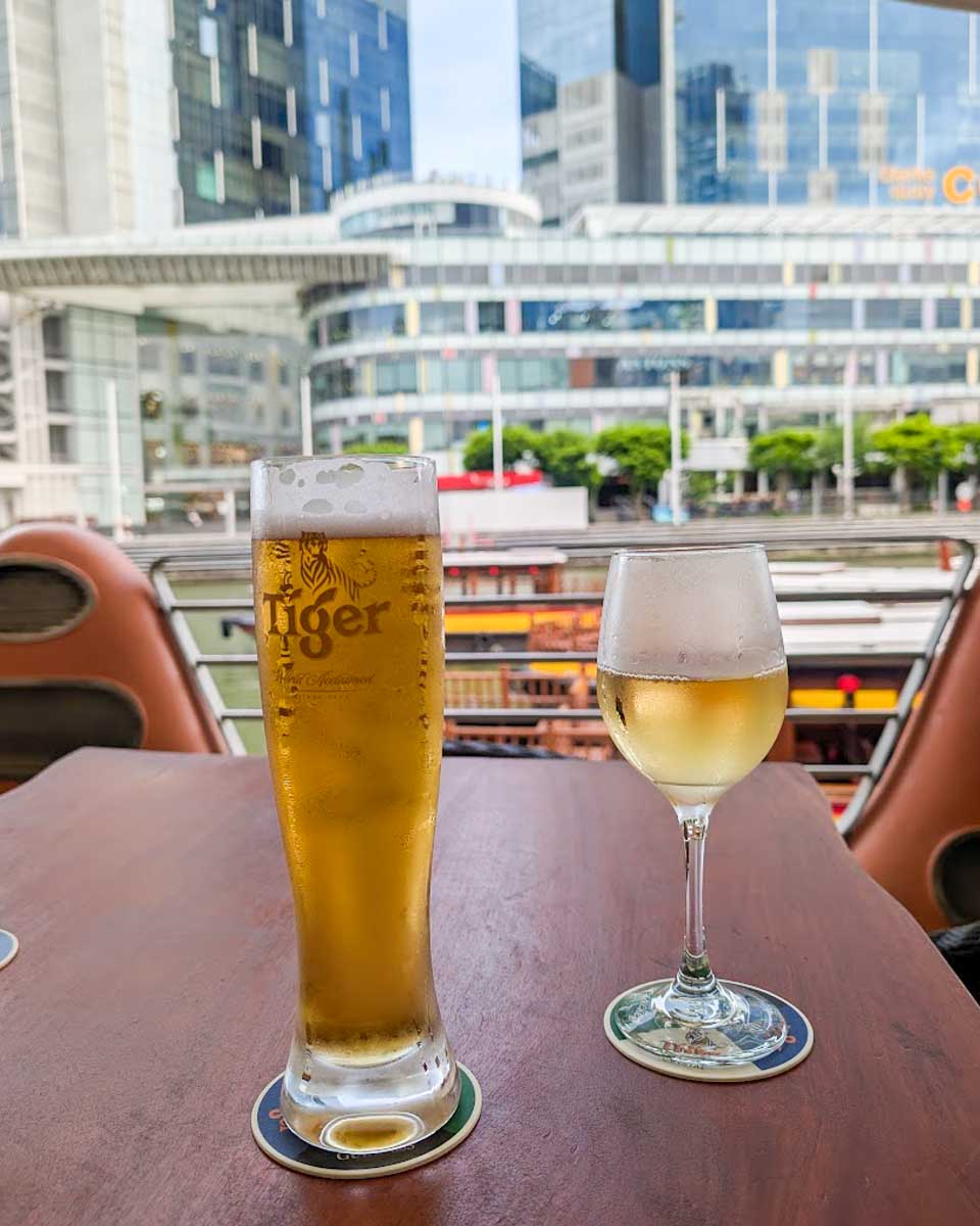 Two drinks on a table overlooking the Singapore River