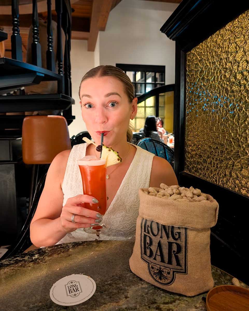 Bailey enjoying a cocktail at Long Bar in Singapore