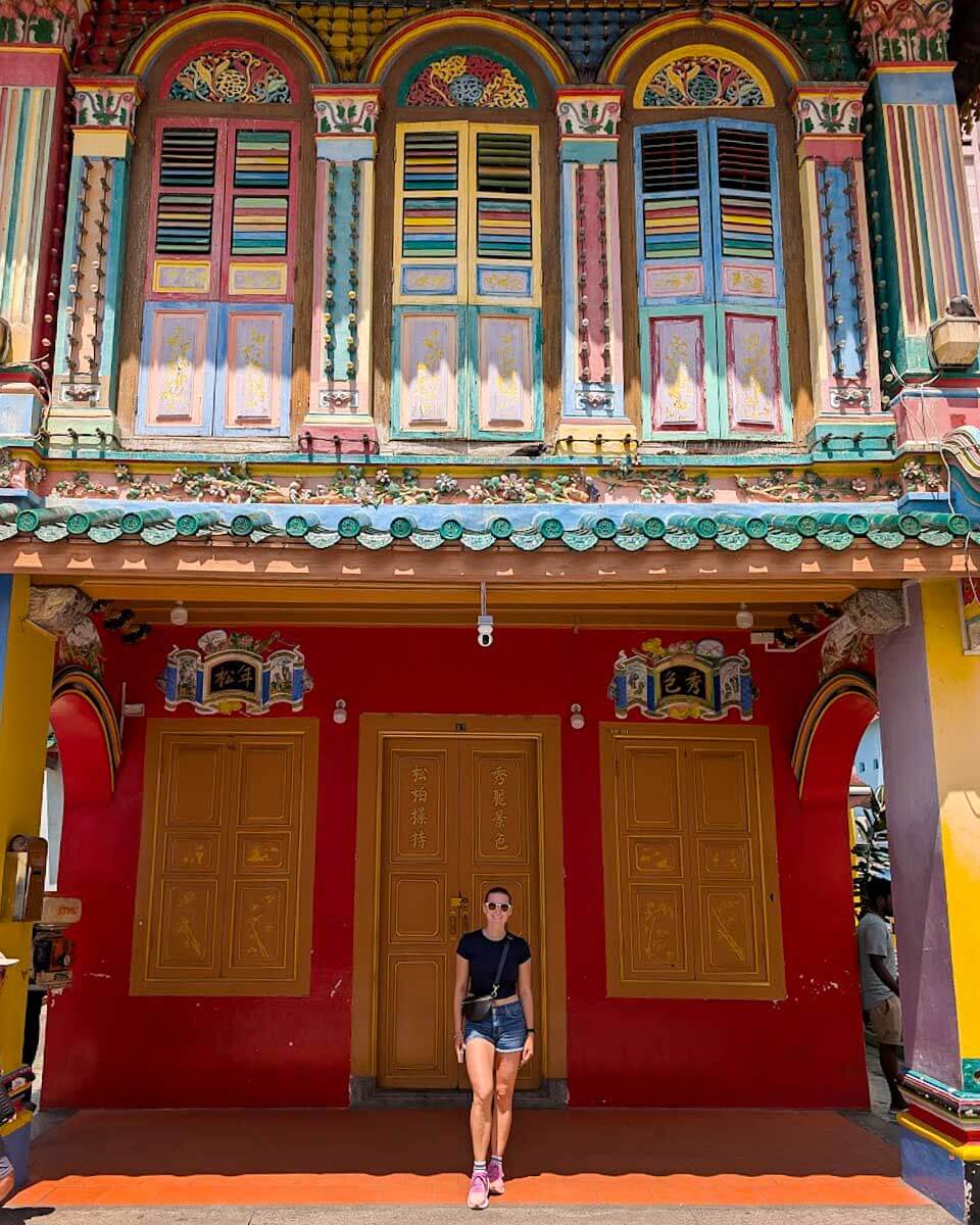 Bailey posing in front of a traditional Chinese villa in Singapore