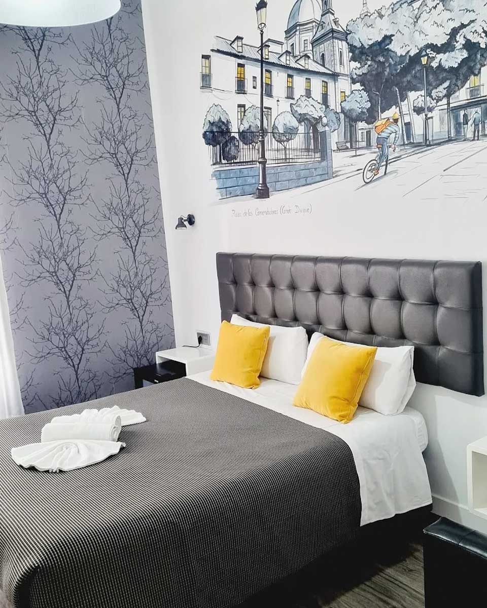 Bed in the hotel room at Hostal Lauria in Madrid copy