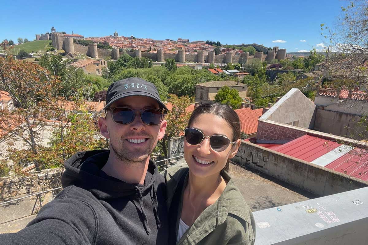Brittni and Jesse take a selfie at a viewpoint over looking Avila Spain