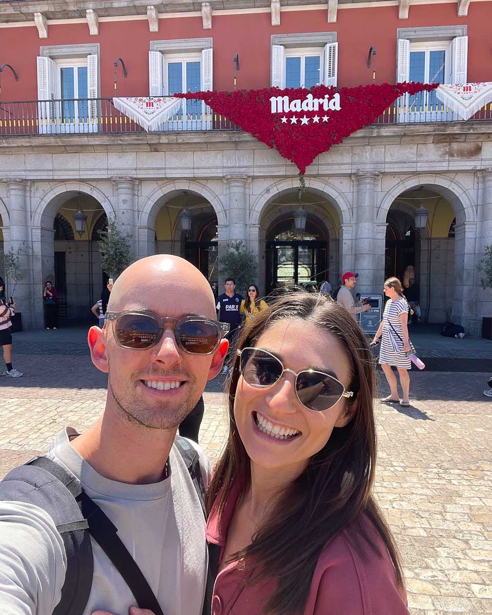 Brittni and Jesse take a selfie in front of a Madrid sign in Plaza Mayor