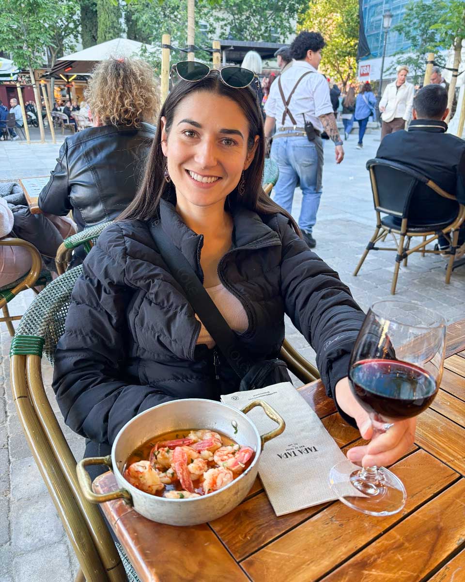 Brittni drinks wine and eats tapas in Madrid