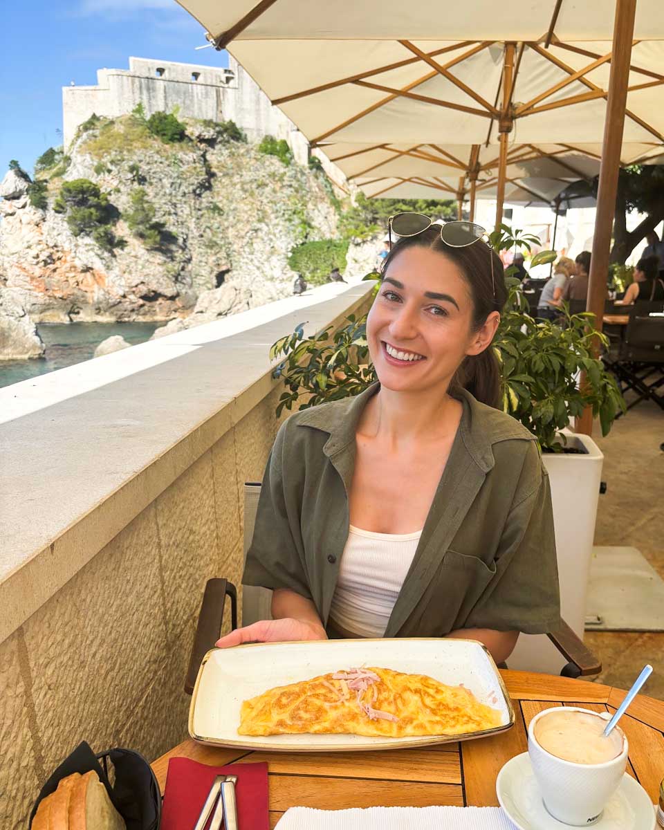Brittni eats an omlette at Dubravka 1836 Restaurant in Dubrovnik