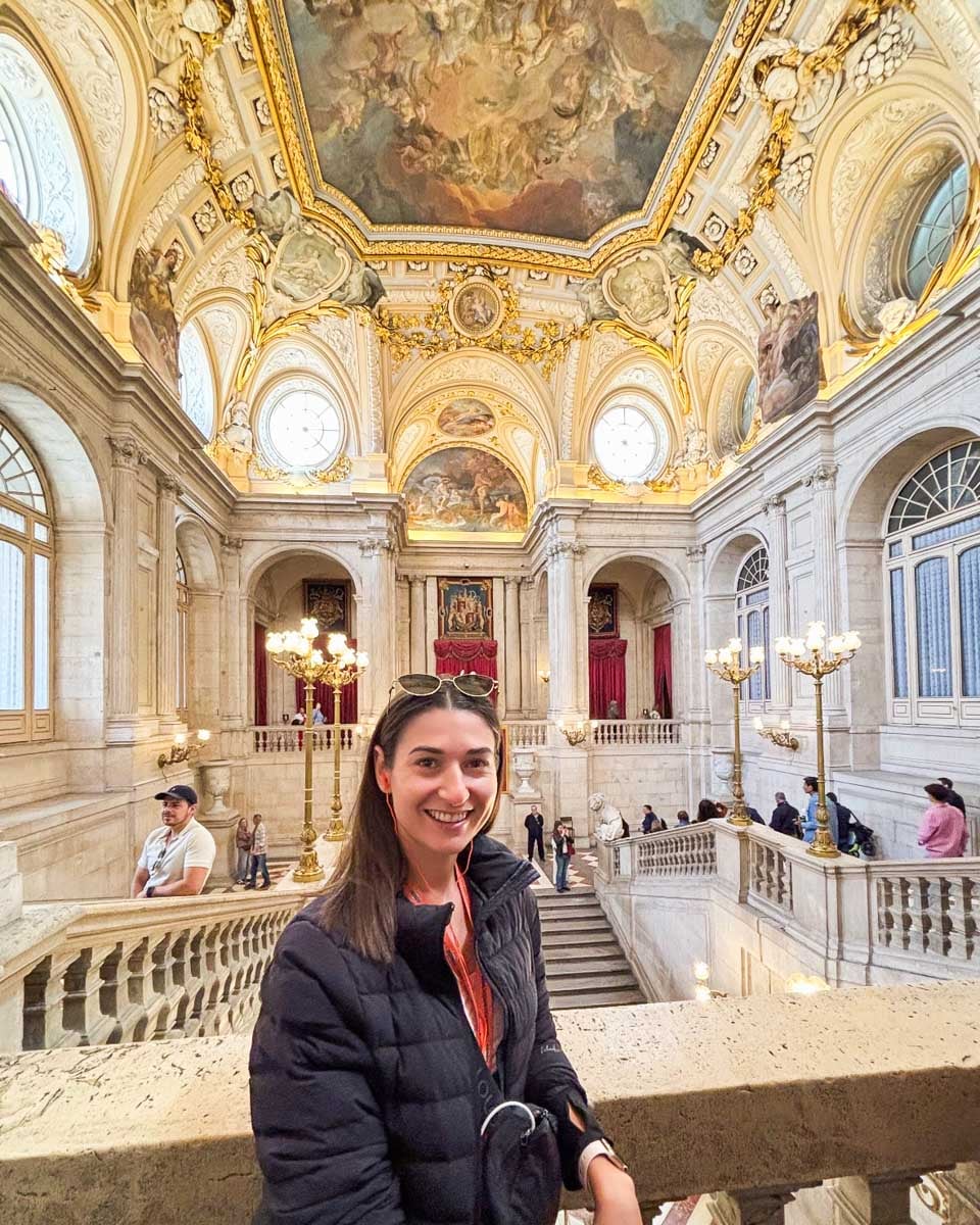 Brittni poses for a photo near the grand staircase in the Royal Palace of Madrid