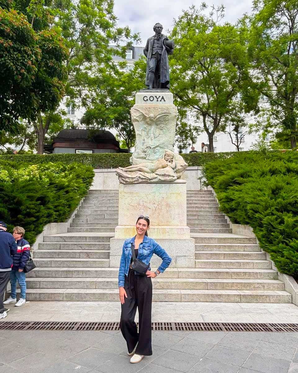 Brittni-poses-in-front-of-the-Goya-statue-outside-the-Prado-Museum-in-Madrid