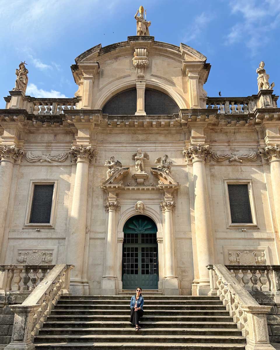 Brittni sits on the steps of Church of St. Blaise in Dubrovnik