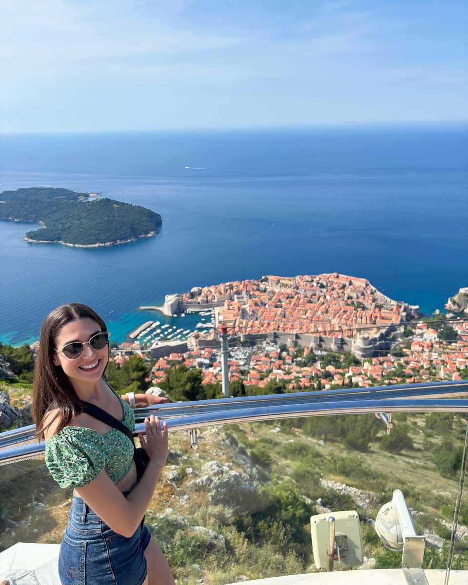 Brittni smiles on top of Mt Srd with a view of Old Town Dubrovnik in the background