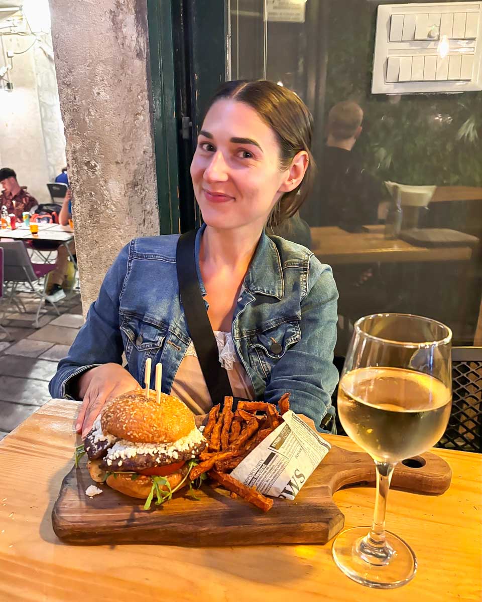 Brittni smiles with her goat cheese burger from Burger House Republic in Dubrovnik