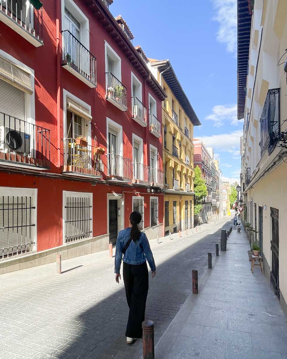 Brittni walks along a street in Barrio de Les Letras Madrid