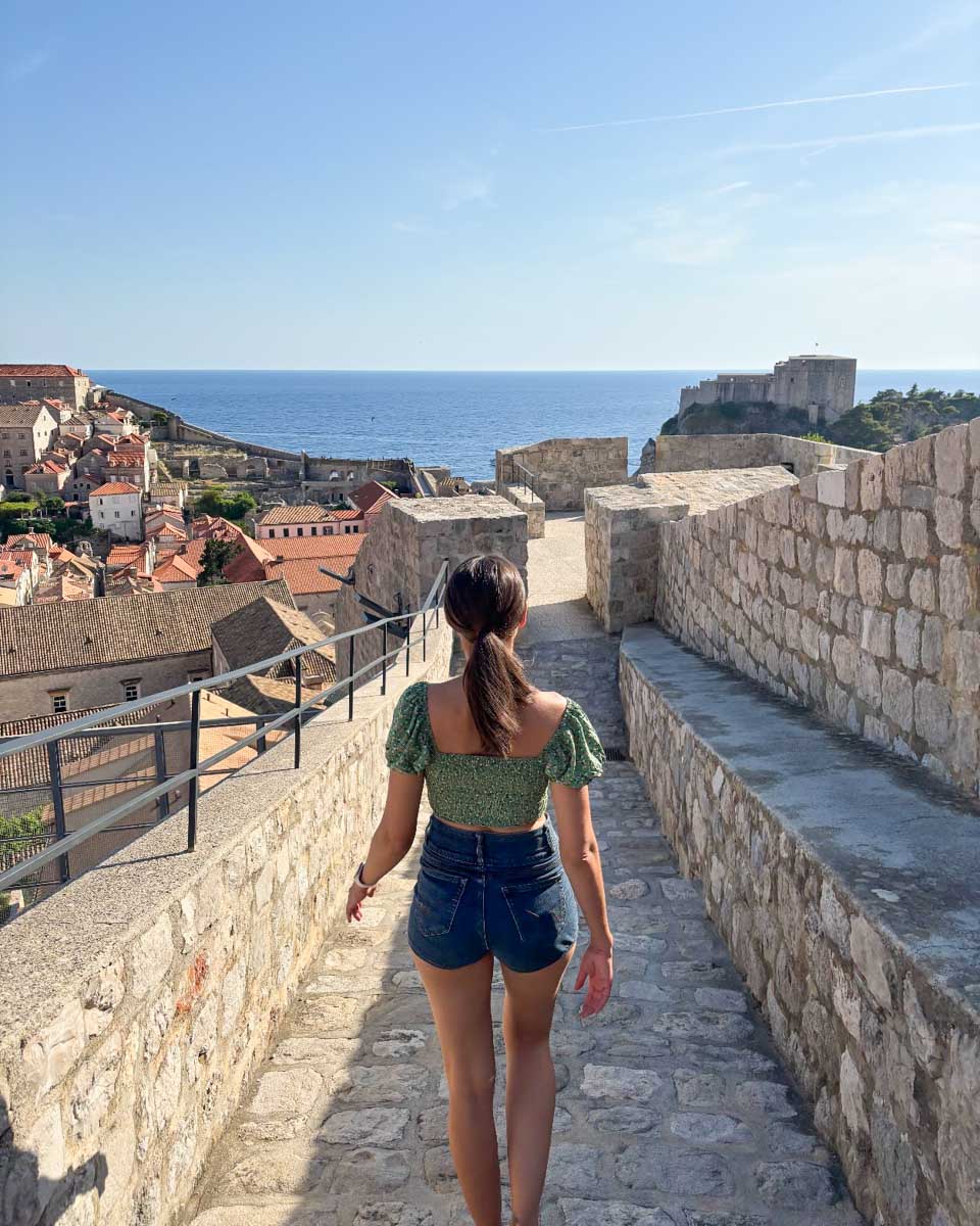 Brittni walks along the city walls in Dubrovnik, Croatia