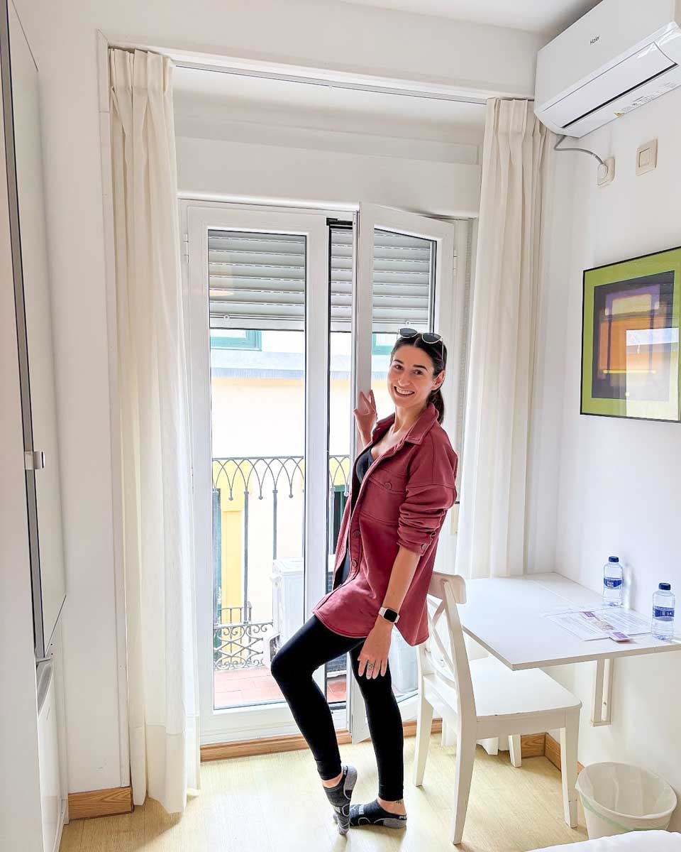 Brittni walks onto the balcon at Hostal Adriano in Madrid