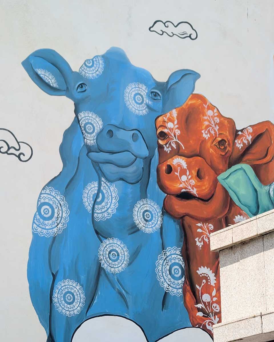 A colorful cow mural on a wall in Little India in Singapore