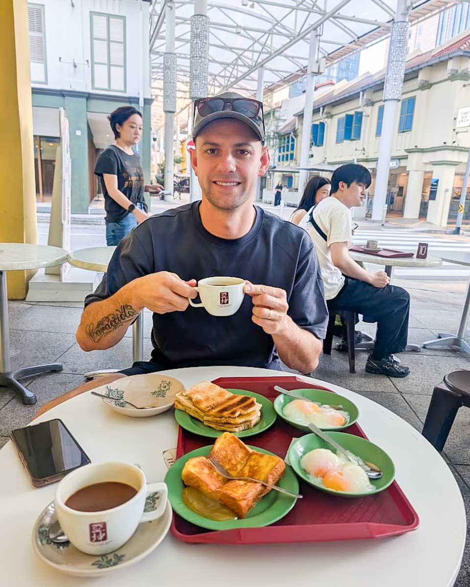 Daniel having coffee at Ya Kun Kaya Toast in Singapore