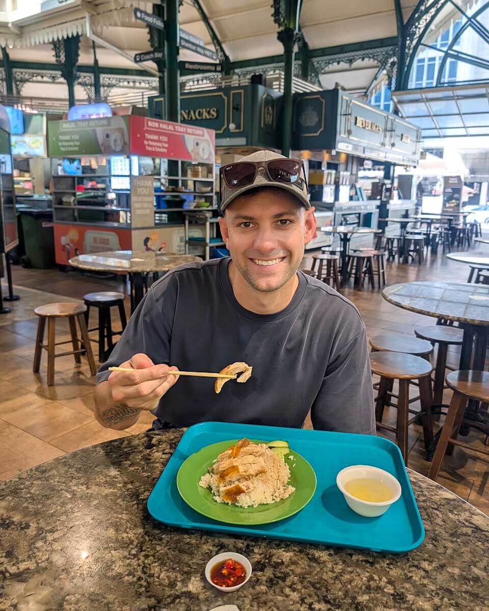 Daniel enjoying soya sauce chicken rice during a Singapore food tour