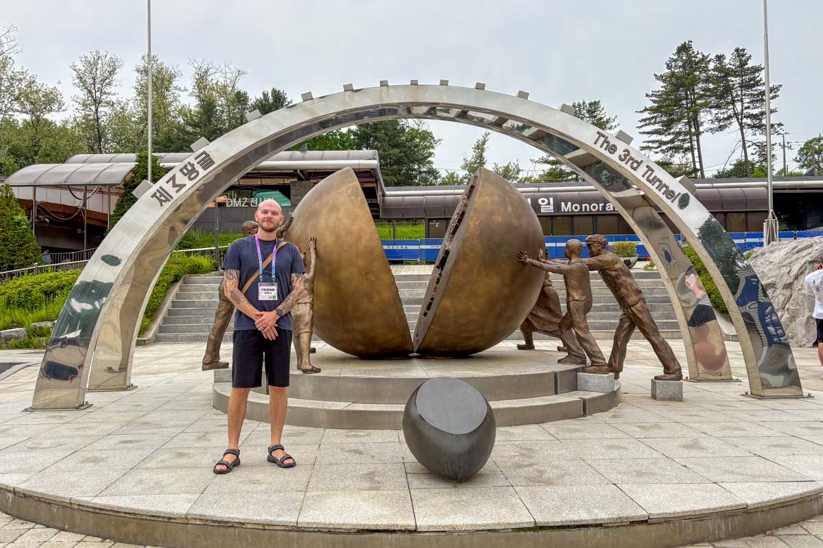 Evan standing at a monument for the reunification of Korea at the 3rd Infiltration Tunnel on a DMZ tour from Seoul South Korea 5