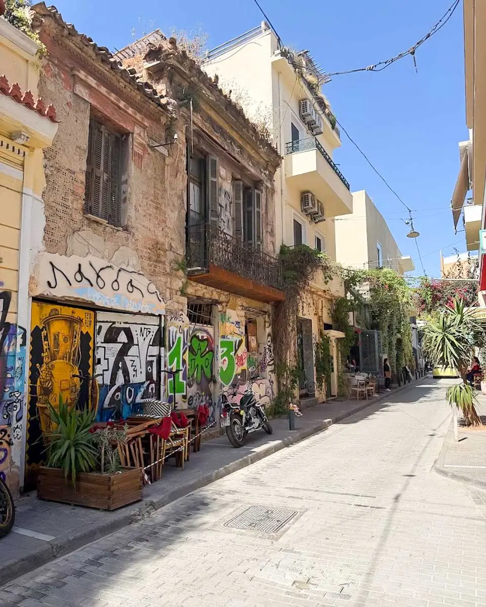 A quiet street in Psyrri with colorful graffiti and old buildings