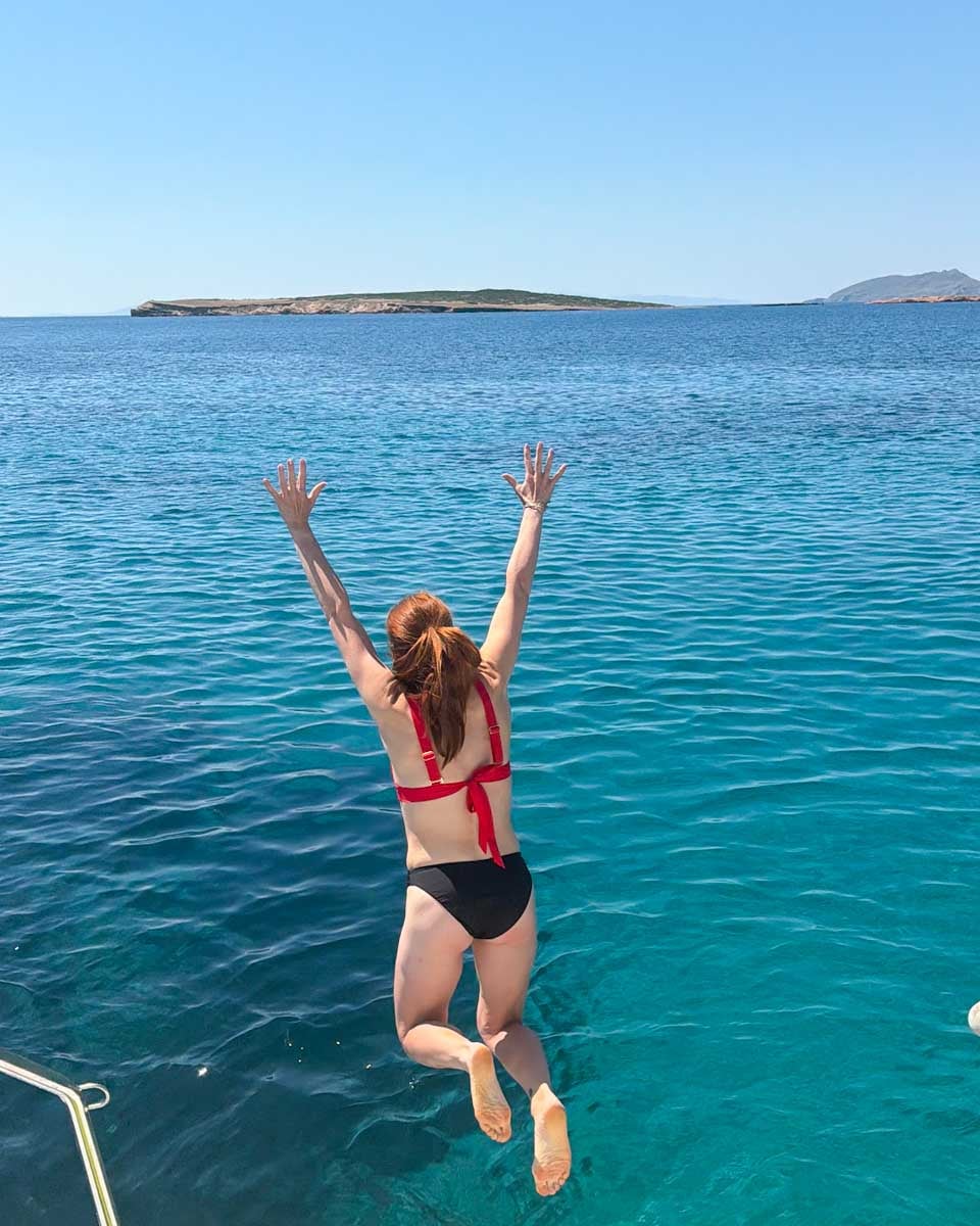 Hannah jumps off a catamaran in Santorini