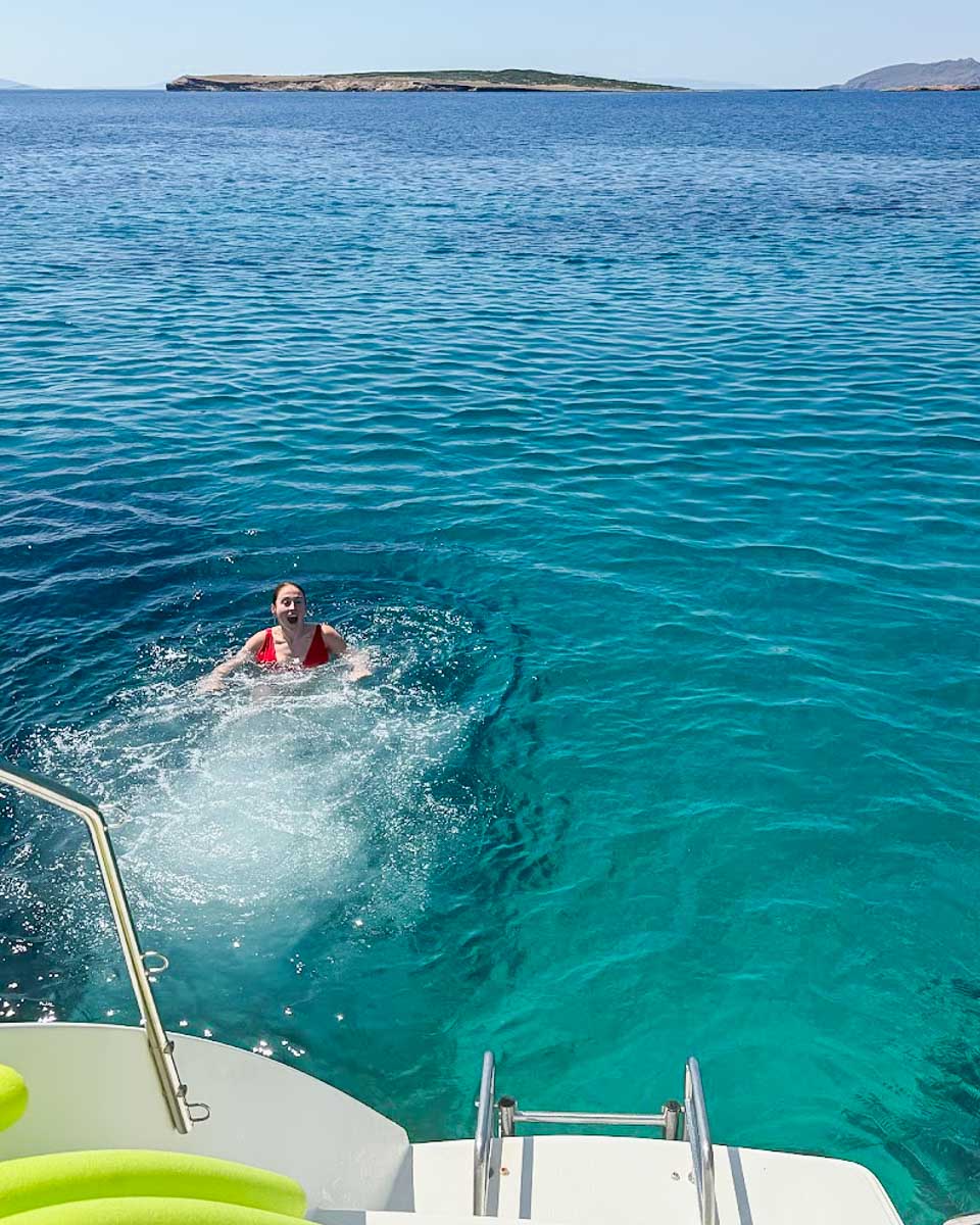 Hannah swimming in the crystal-clear waters during a cruise tour in Athens, Greece