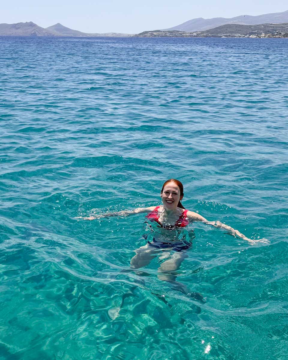 Hannah swims on a boat tour in Santorini