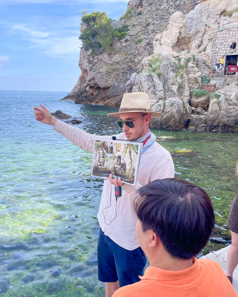 Our tour guide shows a photo on a Game of Thrones tour in Dubrovnik
