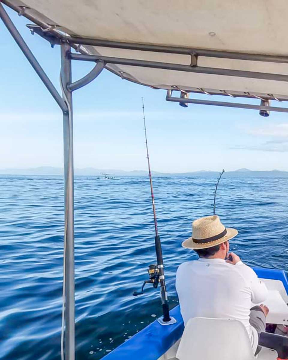 People fishing off a boat in Santorini Greece
