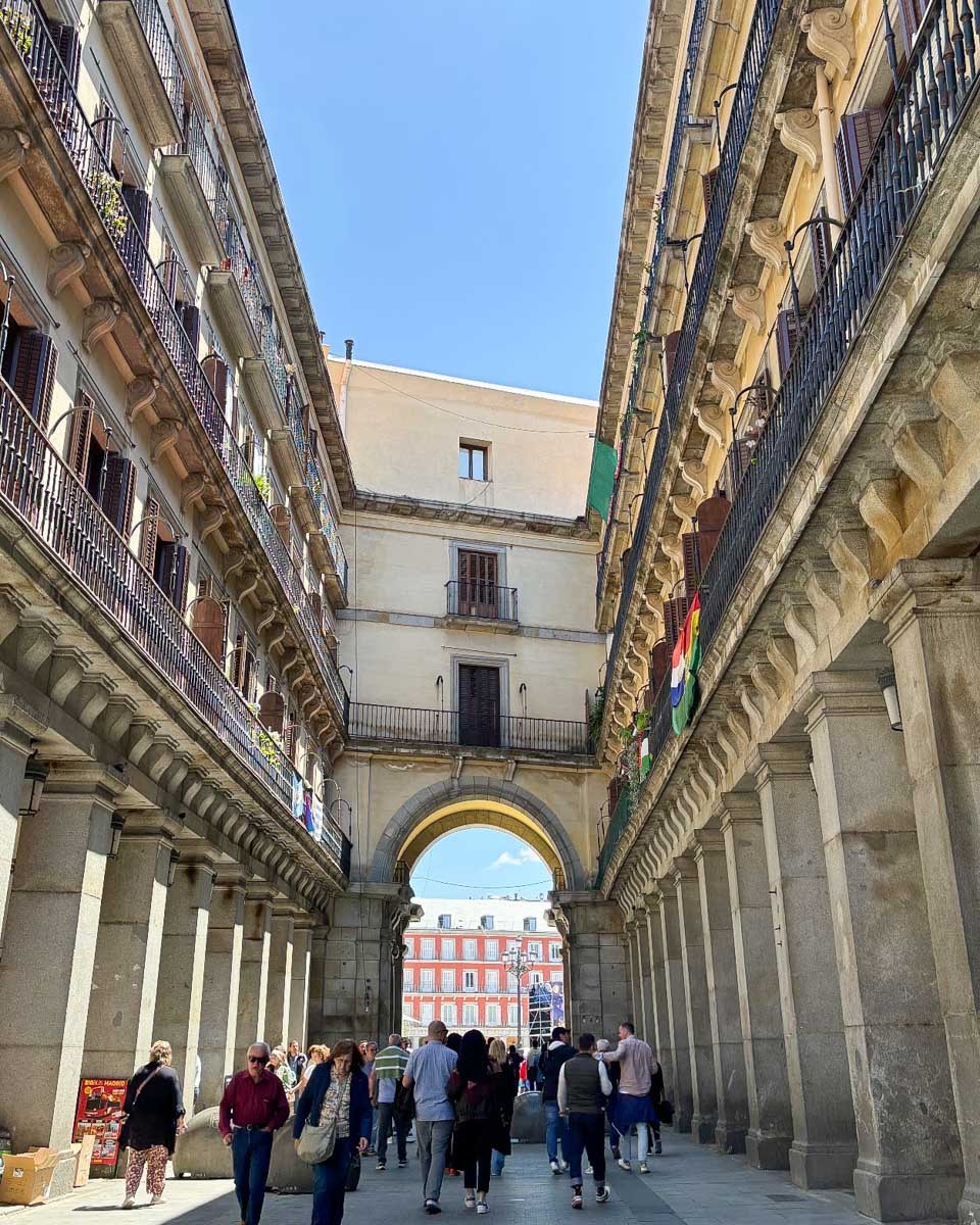 People walk entering Plaza Mayor in Madrid