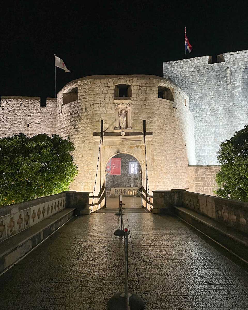 Pile gate lit up at night in Dubrovnik