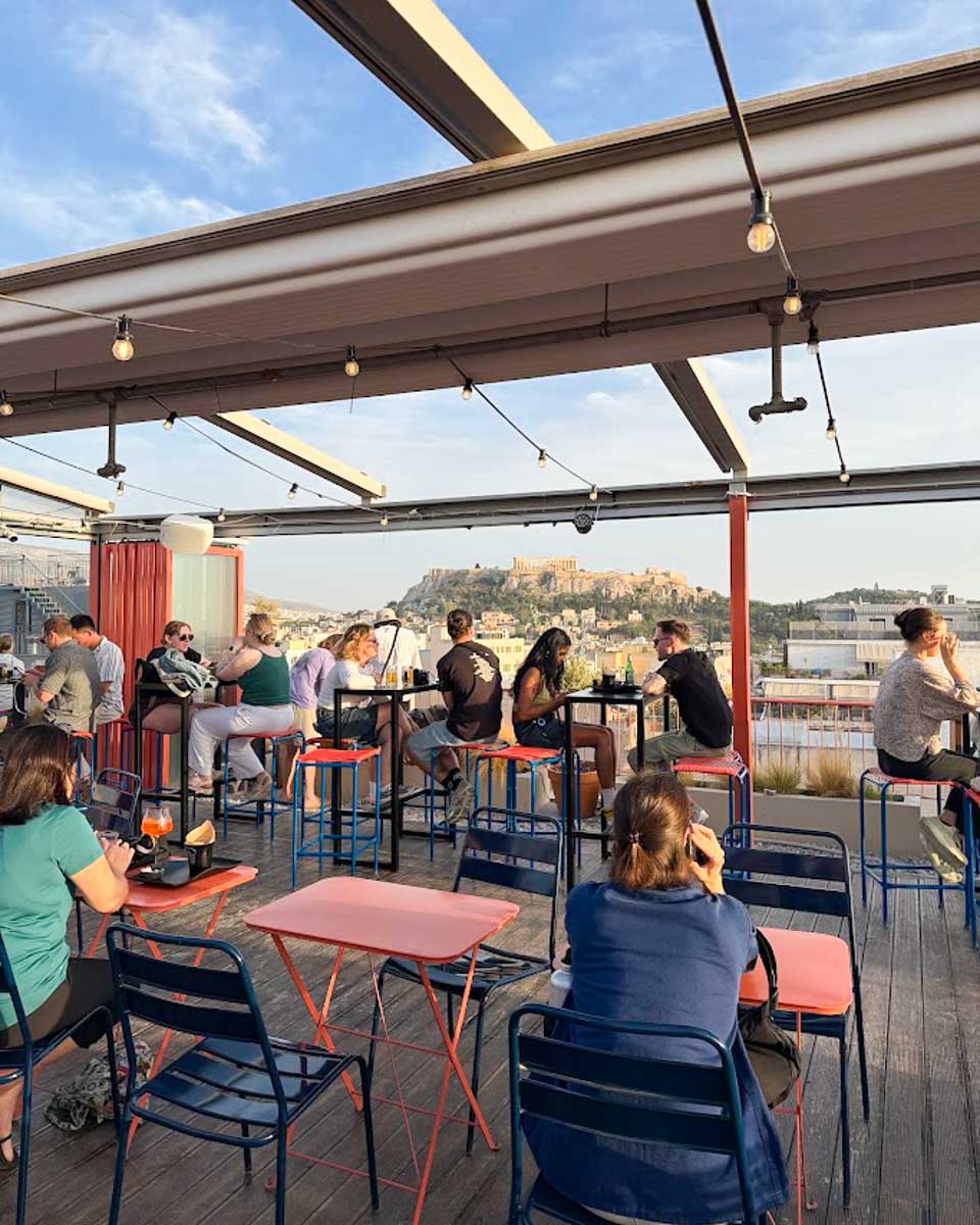 Guests relaxing at the rooftop bar at YellowSquare Athens