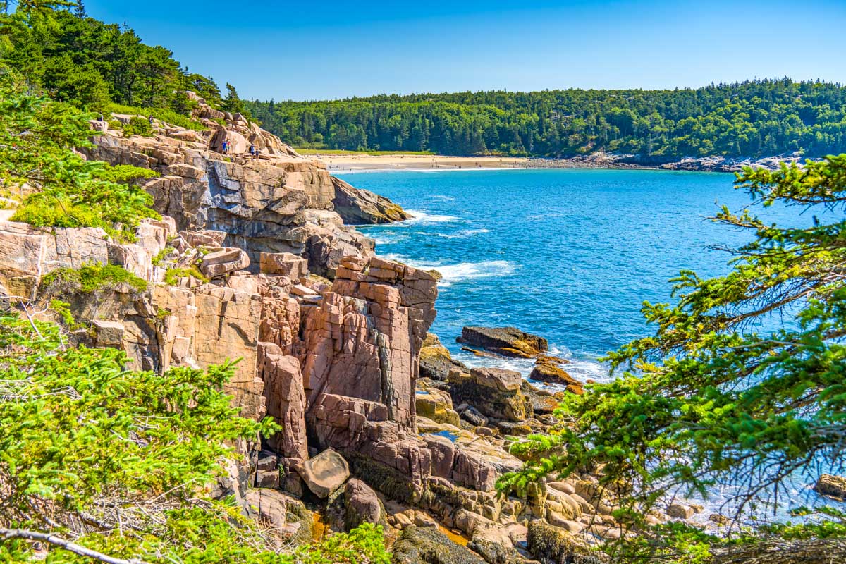 Sand-Beach-in-the-distance-of-rocky-coastline-at-Acadia-National-Park-near-Bar-Harbor-Maine