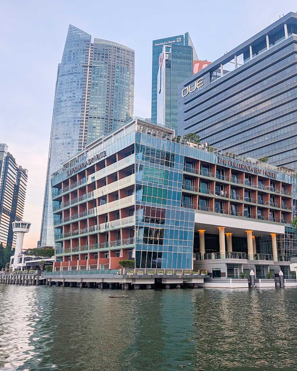 The Fullerton Bay Hotel viewed from the water, with the OUE Bayfront skyscraper behind it, Singapore