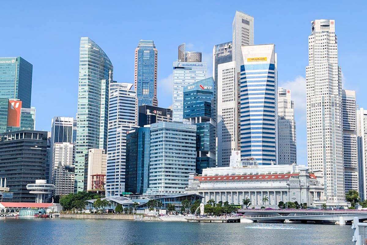 Singapore skyline overlooking the Singapore River with modern skyscrapers and the historic Fullerton Building
