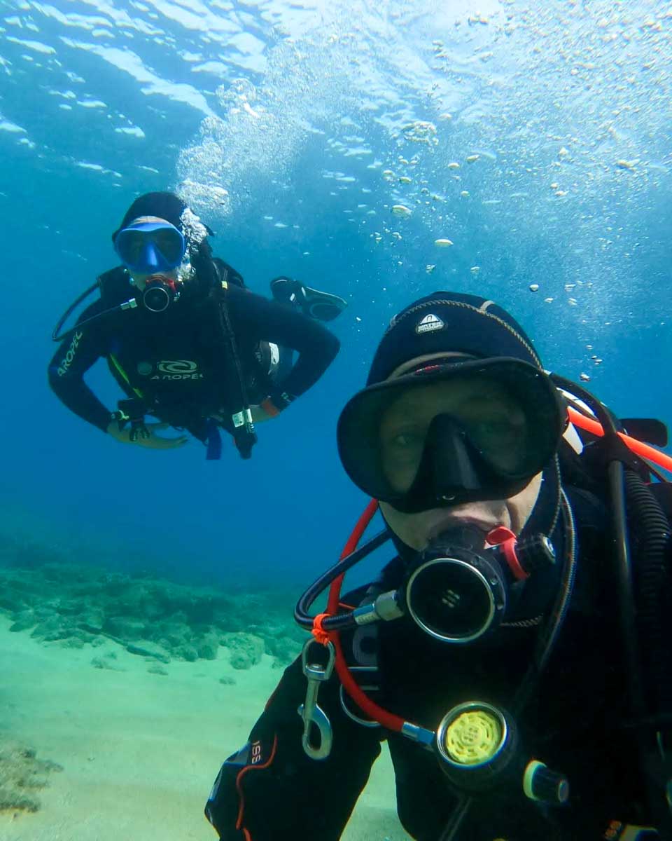Two scuba divers exploring the underwater world off the coast of Naxos