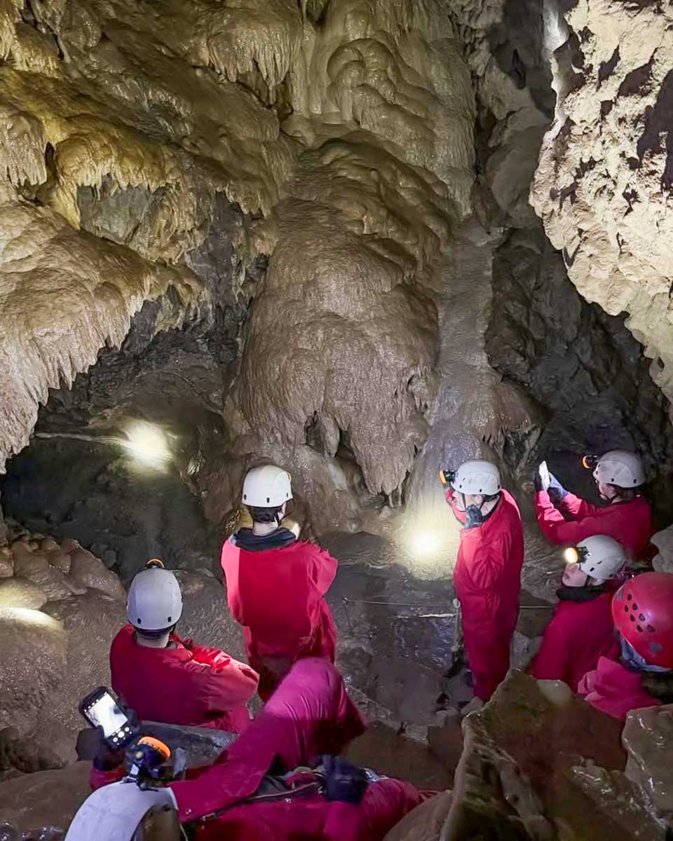 A group explores a cave with Canmore Cave Tours