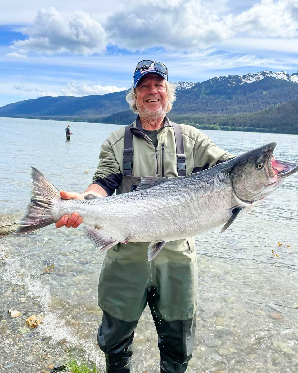 A man hold up a fish caught on a tour with Alaska Anglers Club in Juneau