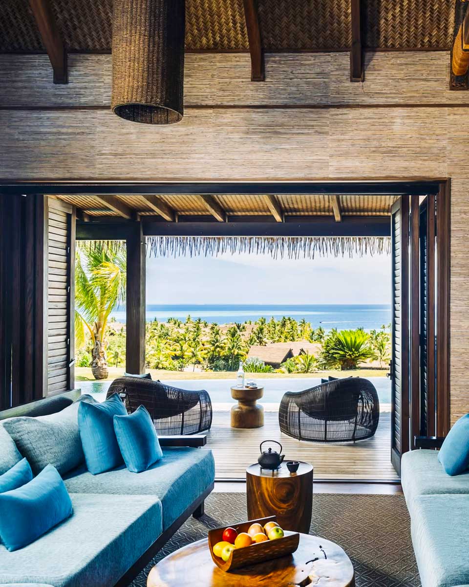 A room with a balcony overlooking the ocean at Six Senses Fiji