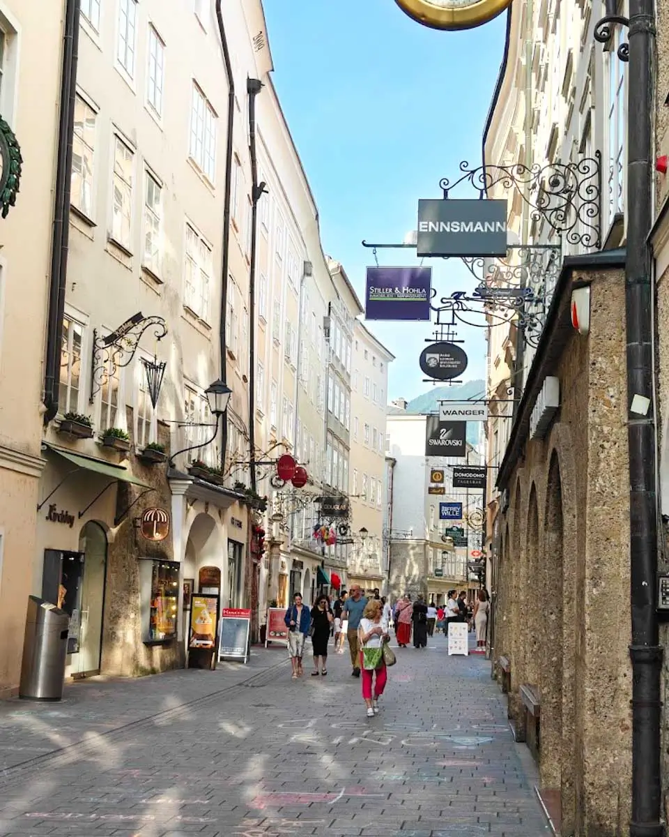 A street lined with buildings and shops in Old Town Salzburg
