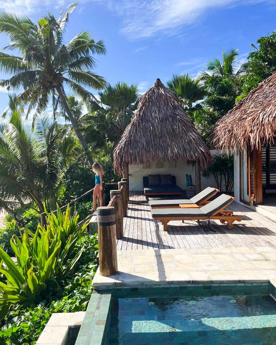 A-woman-stand-outside-her-room-next-to-the-pool-at-Tokoriki-Island-Resort-Fiji