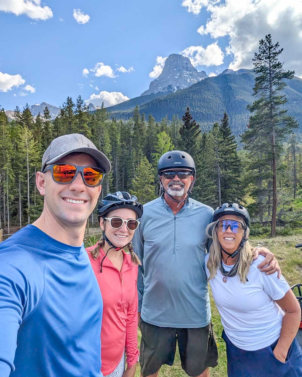 Bailey and Dan smile with friends on an e-bike tour in Canmore, Alberta